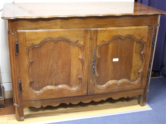 An 18th century French provincial walnut cabinet, with serpentine top and two panelled doors, W.138cm D.63cm H.95cm